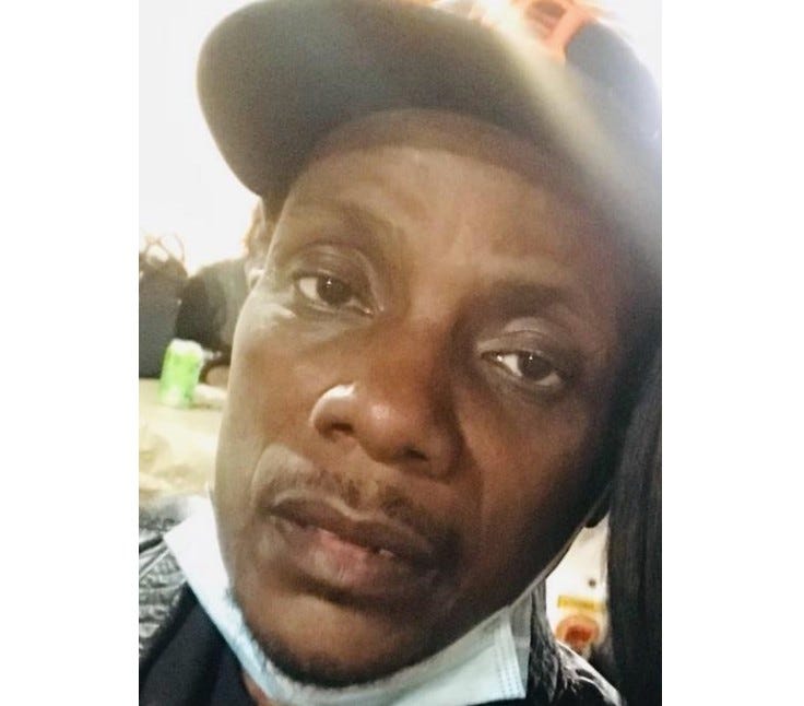 Older Black male looking at camera 