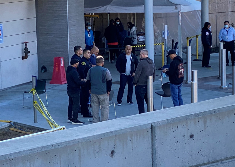 Star Protection Agency colleagues wait outside Oakland's Highland Hospital.