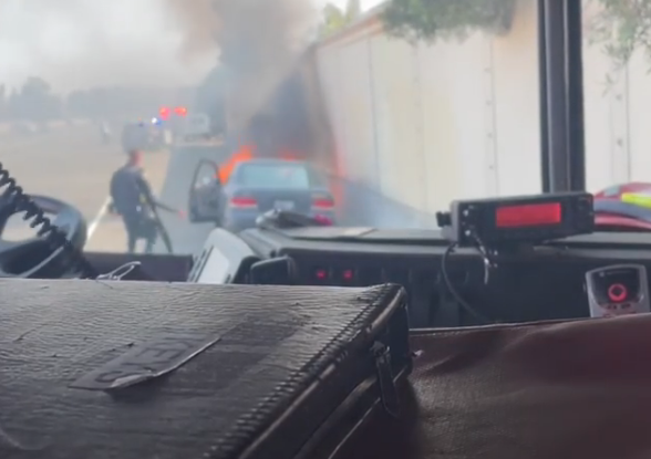 Officer Pedro Garcia heroically rescuing man from burning vehicle.