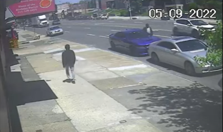 A suspect is shown in surveillance video walking past the vehicle he is later suspected of carjacking.