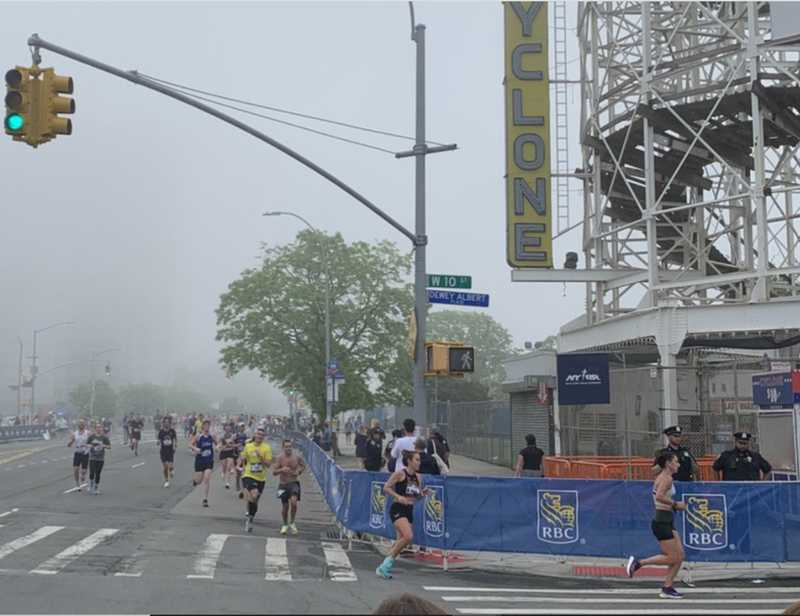 Participants run in the RBC Brooklyn Half Marathon, where fifteen people were injured and one died due to heat.