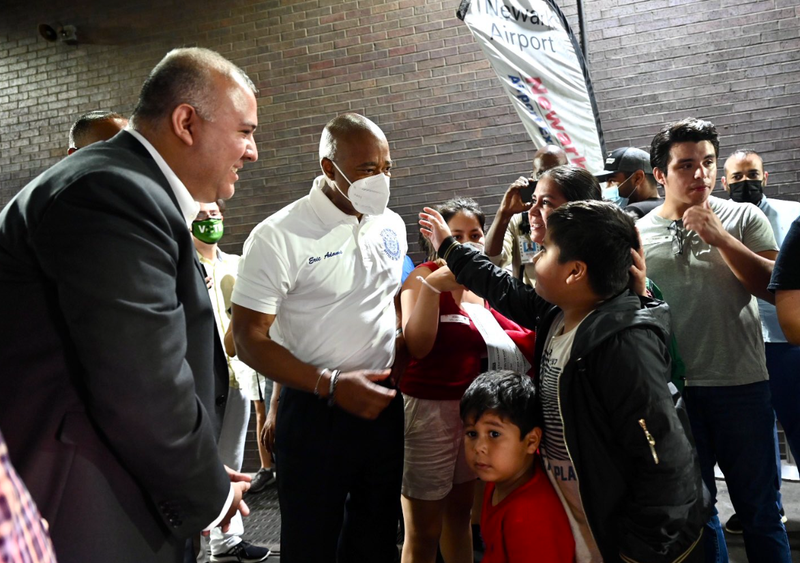 Adams greets a group of children seeking asylum in the U.S. who arrived in New York City on Sunday.