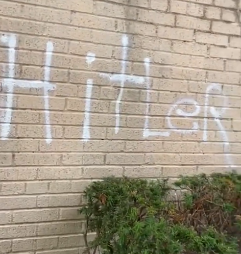 The word "Hitler" scrawled  on the wall of a Brooklyn synagogue.