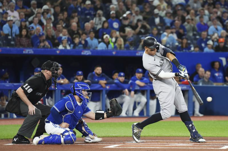 New York Yankees' Aaron Judge lines out to third as Toronto Blue Jays catcher Alejandro Kirk watches during the first inning of a baseball game Tuesday, Sept. 27, 2022, in Toronto.