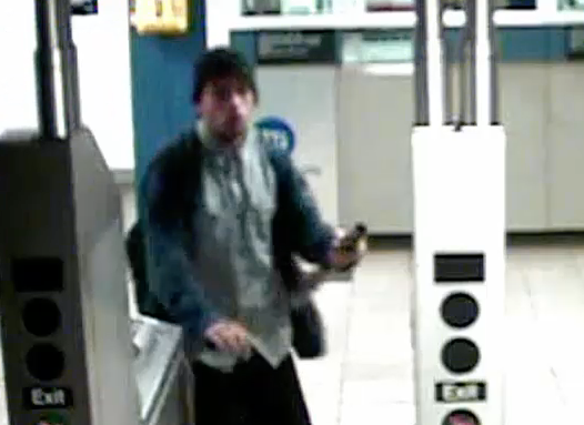 The suspect appears to be holding the metal pipe in surveillance footage from the station