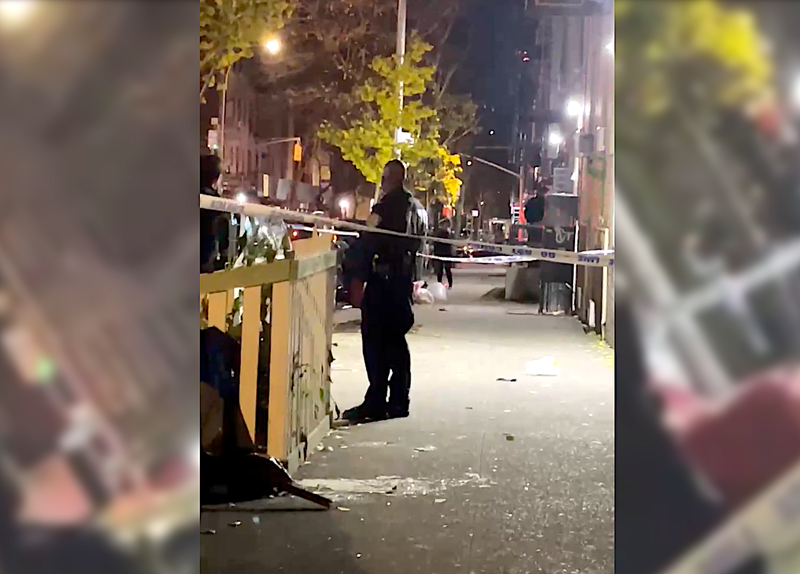 The victim was shot by two masked men as he walked with a friend on a sidewalk