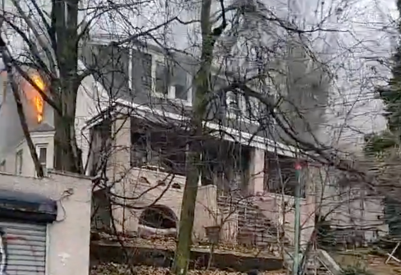 Flames could be seen shooting out of the three-story home during Friday's blaze.