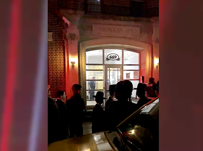 Police in the lobby of the building where a woman was found dead Wednesday night