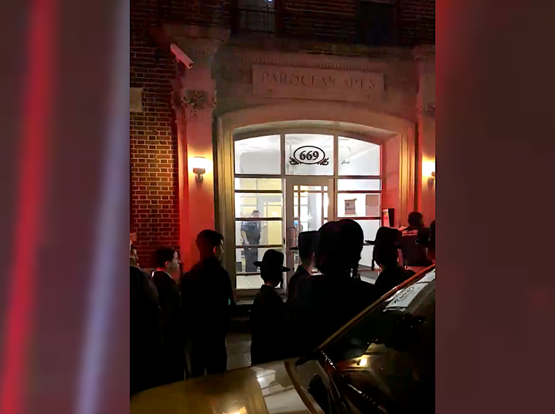 Police in the lobby of the building where a woman was found dead Wednesday night.