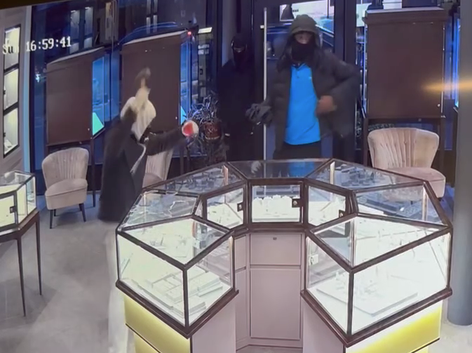 Video shows the trio smashing glass display cases and tossing merchandise into bags on the evening of Jan. 8, 2023