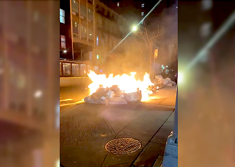 At least one pile of trash was set on fire in the spree, video shows