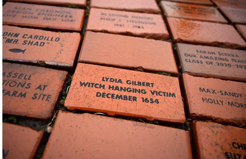 In this Tuesday, Jan. 24, 2023 photo, a brick memorializing Lydia Gilbert is placed in a town Heritage Bricks installation in Windsor, Conn.