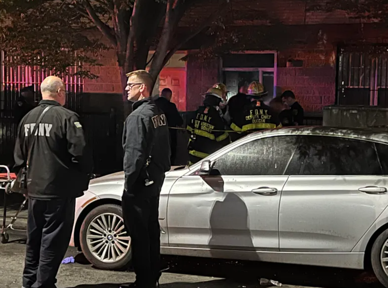 Emergency responders surround the East New York building where two people were killed and four were injured.