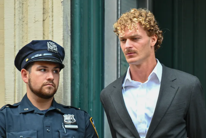Daniel Penny is escorted in handcuffs by the NYPD after turning himself into the 5th Precinct on May 12, 2023. 