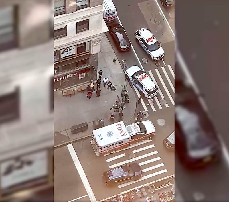 Police and EMS at the scene of the robbery at E. 36th Street and Fifth Avenue on June 19