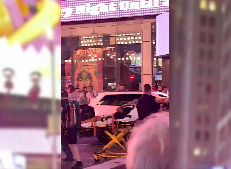 A patient is wheeled away on a stretcher after the shooting
