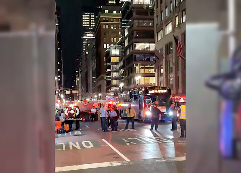 The bucket appears to have scraped against the bus' windows, causing several of them to shatter