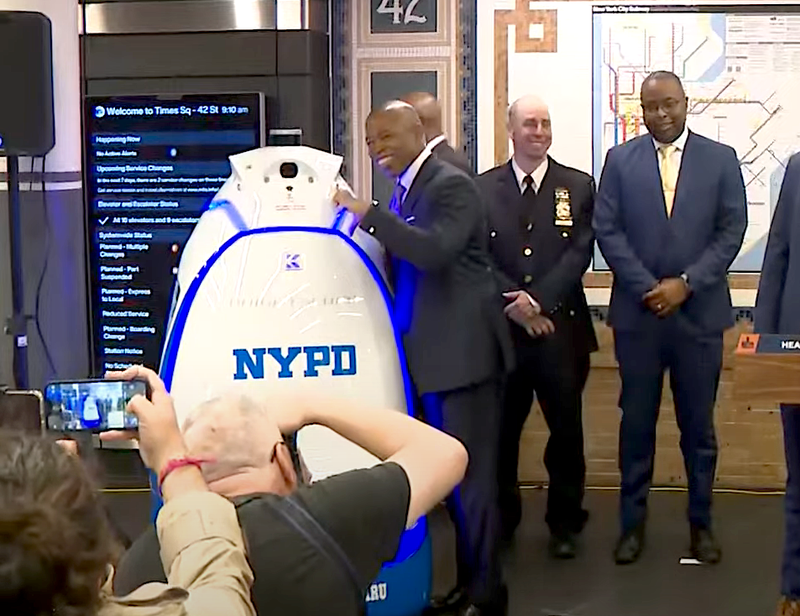 Mayor Eric Adams poses beside K5 at a news conference inside the Times Square subway station on Sept. 22, 2023