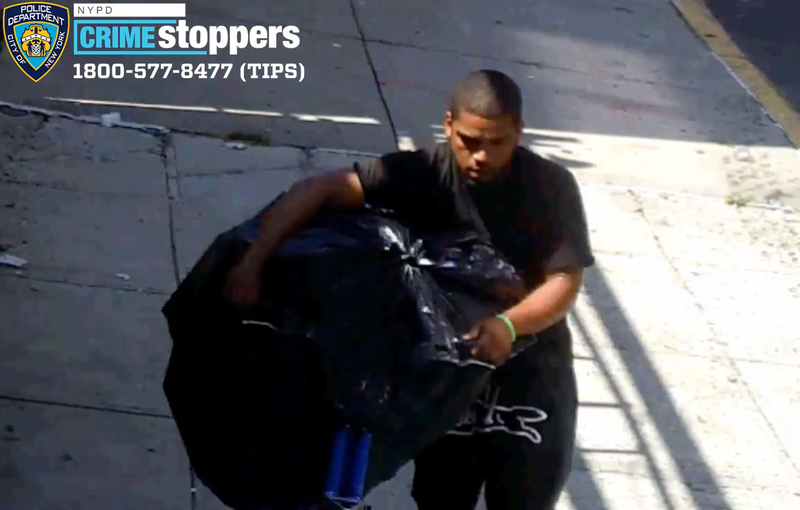 Video shows the suspect walking down a sidewalk with a stuffed trash bag