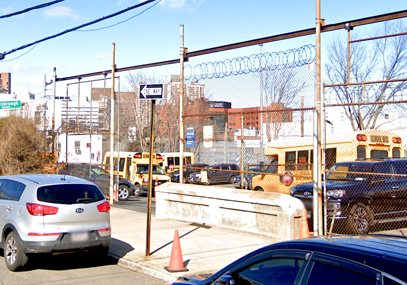 Men have been busy emptying this Blondell Avenue parking lot of its mini school buses