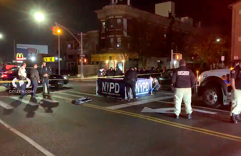Police put up a barrier to block the body of a man who was struck and killed by two drivers in Borough Park on Tuesday night