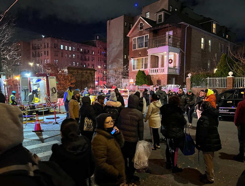 Residents gather around the collapse scene on Monday evening