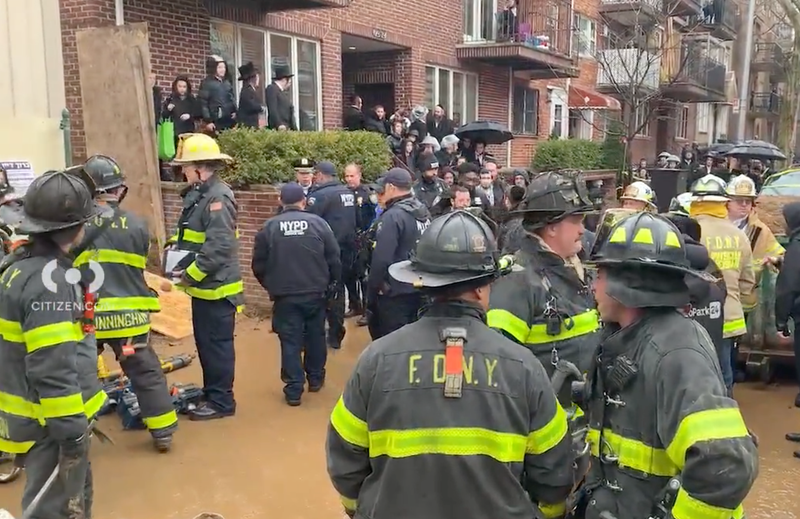 Crowds gathered at the scene of the collapsed amid an FDNY operation