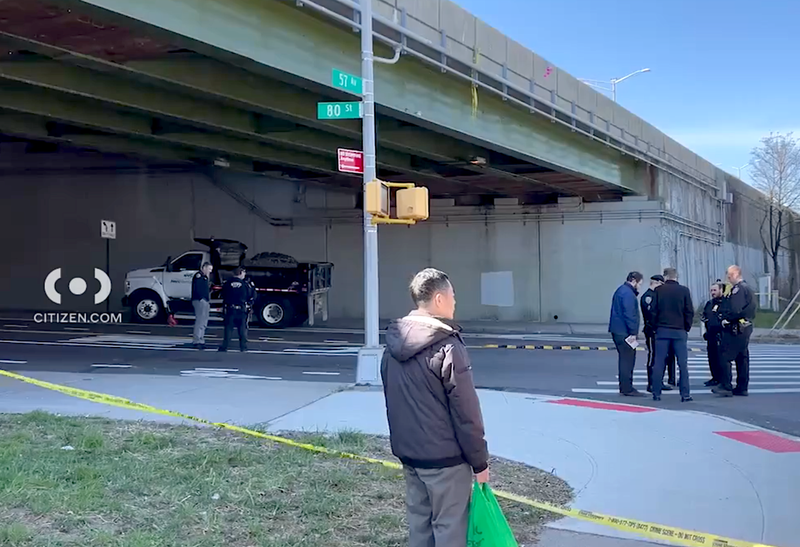 The woman was hit by a turning DEP truck in Elmhurst Tuesday morning, police said