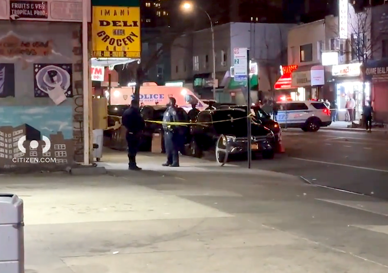 Police investigate at the scene of the double shooting in Brownsville