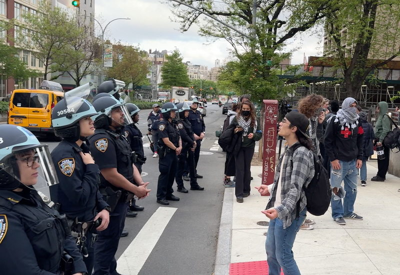 NYPD officers and students are seen near the NYU encampment on May 3, 2024