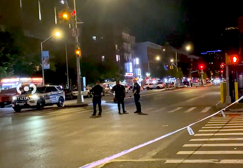 NYPD officers at the scene of the crash at Lenox Avenue and West 135th Street