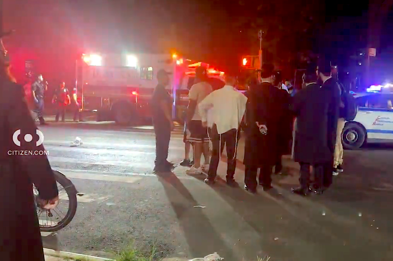 Residents watch as police and EMS respond to the shooting at 29 Ryerson St. in Clinton Hill