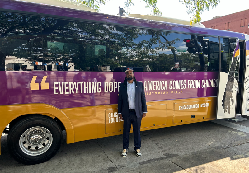Chicago historian Dilla poses for a photo in front of his tour bus