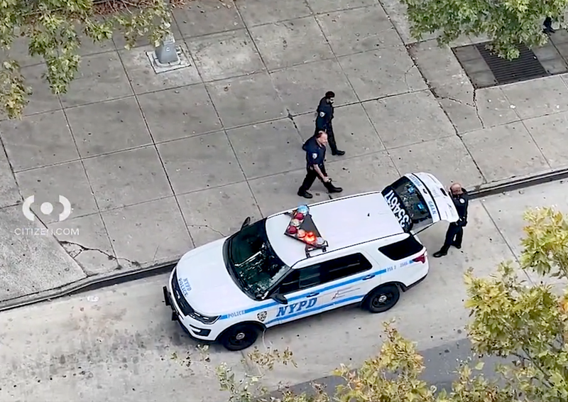 NYPD officers were seen outside the Lafayette Gardens Houses after the shooting Monday evening