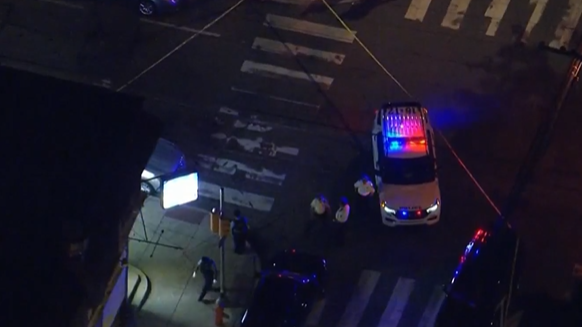Police hold the scene of a robbery attempt-turned-shootout at a West Philadelphia corner store.