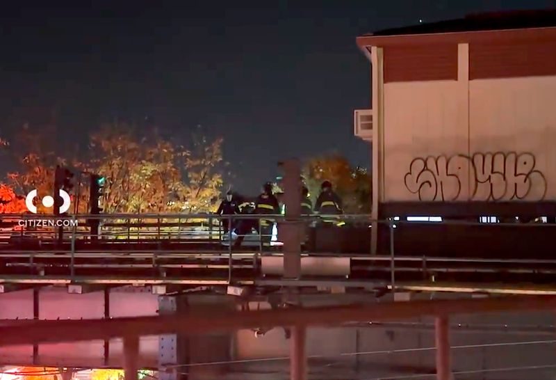 Firefighters are seen on the tracks at the Forest Avenue subway station on Wednesday night