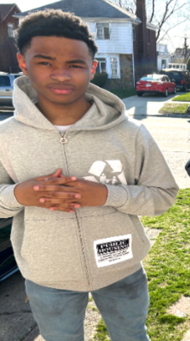 Teen boy in front of house on grass