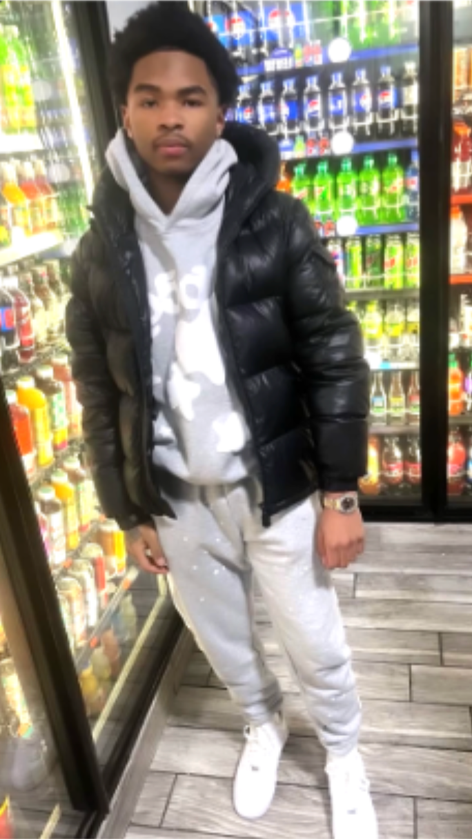 Boy in front of soda display