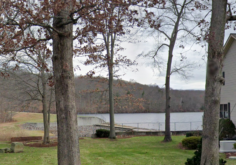 The woman plunged through the ice into Bolton Lake in Vernon around 10:30 a.m. Wednesday, police said