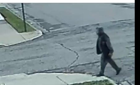 Man in sweatsuit walking down the street