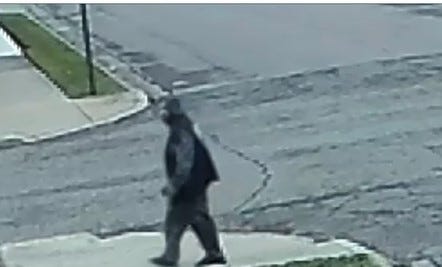 Man in sweatsuit walking down the street