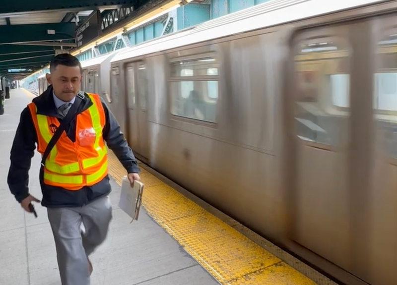 An MTA worker walks the platform of the station on Friday morning
