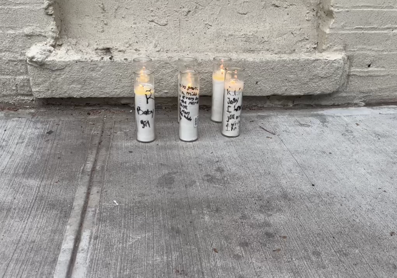 Candles were placed near the school on Tuesday at a makeshift memorial
