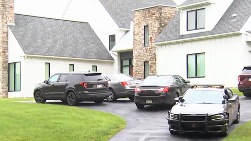 State police cars and other investigators' vehicles in front of a Chester County home