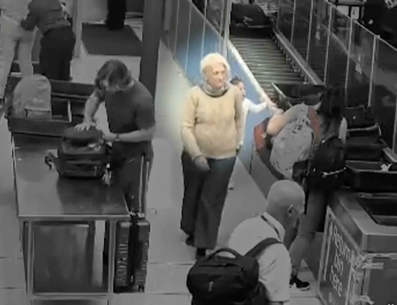 Surveillance video shows the woman who was able to sneak onto a New York-to-Paris flight without a boarding pass late last year got on the plane by glomming onto a group of passengers as they passed gate agents