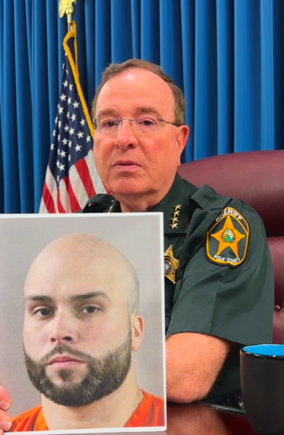 Polk County, Florida Sherriff Grady Judy shows off the mugshot of CPD Officer Dwayne Ocasio