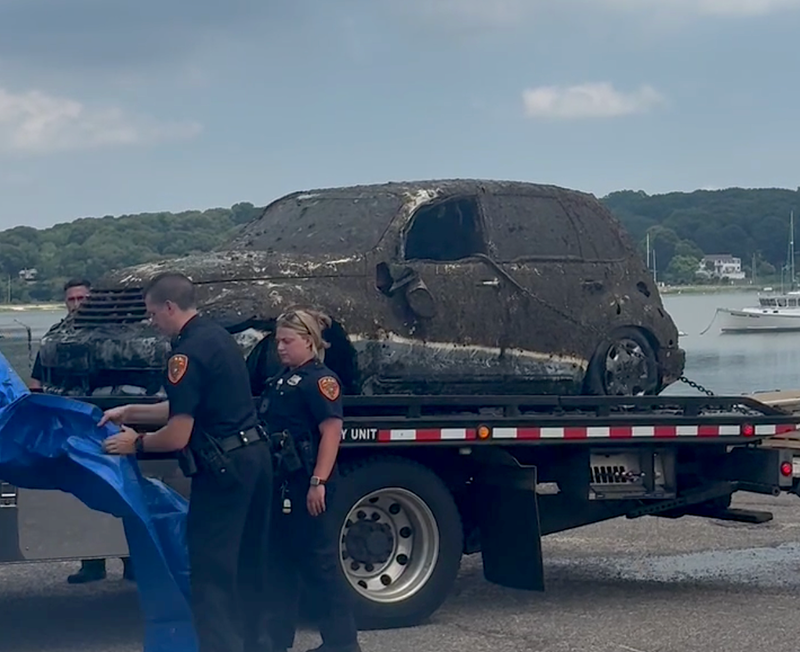Suffolk County police were at Cedar Beach on Tuesday as divers searched a submerged vehicle believed to belong to a man who went missing in 2010