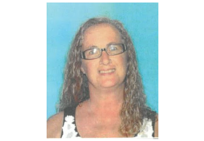 Woman with curly hair and glasses
