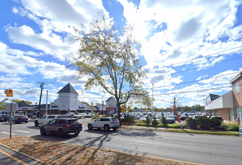 Officers found a 70-year-old man's body in the rear parking lot of Merrick Commons Thursday night.