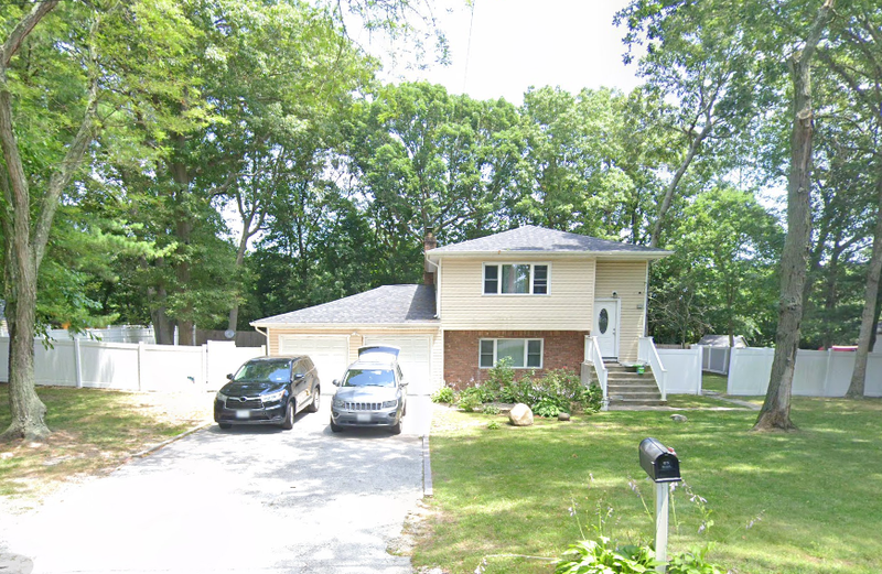A Long Island woman is accused of burning her home down with three children inside last month, police said.